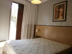 a bedroom with a large bed and a window at Bilo Olivieri Porto Cesareo in Porto Cesareo