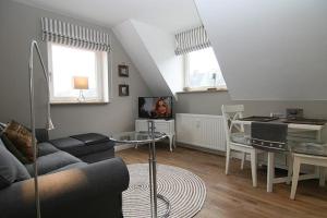 a living room with a couch and a table at Strandperle 03 in Hörnum