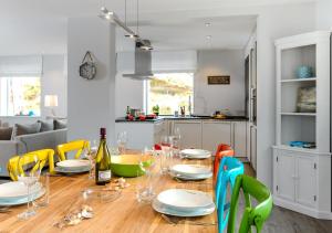 a dining room table with plates and wine glasses at Sylt Hüüs in Hörnum