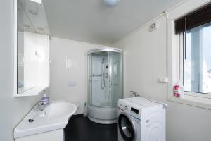a bathroom with a washing machine and a sink at Apt 101 - Andenes Whale Safari Apartments in Andenes