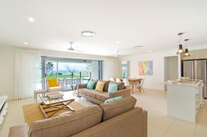 a living room with a couch and a table at Sentosa on Tugun - Beachfront 5 Bedroom in Gold Coast