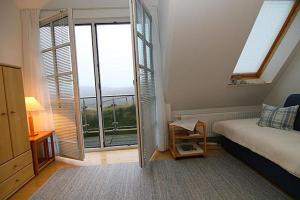 a bedroom with a bed and a large window at Ferienwohnung Filter in Hörnum