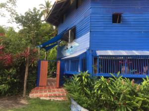 a blue house with a blue gate in front of it at The Hill B&B (El Morro Hosteria) in El Valle