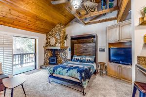 a bedroom with a bed and a fireplace at The Lake House in Shaver Lake