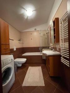 a bathroom with a sink and a washing machine at Antresola apartament Zeta Park in Ustroń