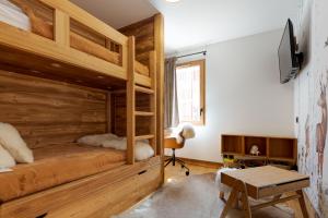 a bedroom with a bunk bed and a desk at Le Refuge des Anges in Megève