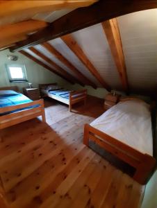 a attic room with two beds and wooden floors at Słonik in Stegers