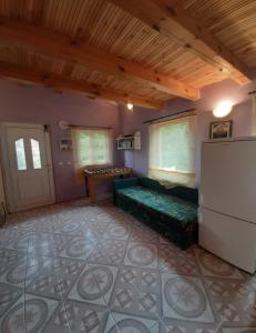 a living room with a couch and a refrigerator at Słonik in Stegers