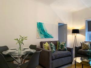 a living room with a table and a couch at Hillington Central in Glasgow