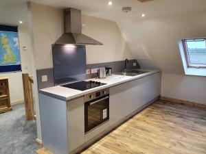 a kitchen with a sink and a stove top oven at Hebridean Stay in Creagorry