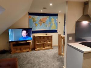a living room with a flat screen tv and a large flat screen at Hebridean Stay in Creagorry