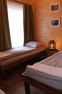 Katil atau katil-katil dalam bilik di Cabanute Premium de pescuit