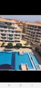 a large apartment complex with a swimming pool and a building at LUX Apartamento in La Mata