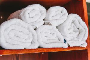 a bunch of towels on a wooden shelf at The Bulls Head in Milnthorpe