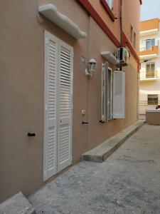 a white door on the side of a building at AP Apartment - in centro! in Gallipoli