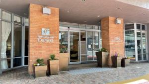a brick building with potted plants in front of it at Holiday Inn Express Vancouver-Metrotown (Burnaby) in Burnaby +68 photos