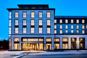 a large building with many windows at dusk at Daxton Hotel in Birmingham