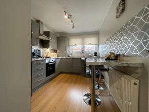 a kitchen with stainless steel appliances and a counter at King Court Apartment in Motherwell