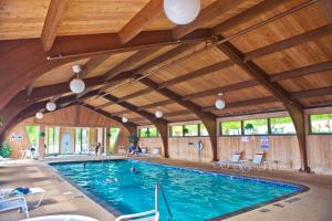 a swimming pool in a building with a wooden ceiling at The Historic Lutsen Lodge in Lutsen