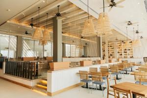 a restaurant with tables and chairs and chandeliers at Emporio Cancun - Buy All Inclusive Option in Cancún