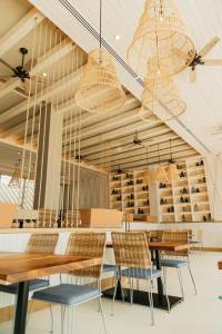 a dining room with tables and chairs and chandeliers at Emporio Cancun - Buy All Inclusive Option in Cancún