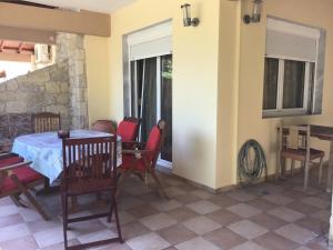 a dining room with a table and chairs in a room at Villa Paradise in Polychrono