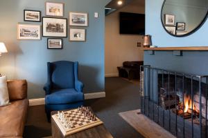 a living room with a fireplace and a blue wall at Robertson Public House and Kitchen in Robertson