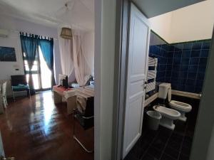 a bathroom with a sink and a toilet in a room at Appartamento Teocle beach in Giardini Naxos