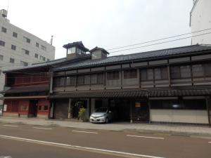 a building with a car parked in front of it at Sumiyoshiya in Kanazawa