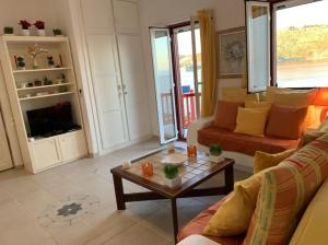 a living room with a couch and a coffee table at Apollon House on the Sea in Mikonos