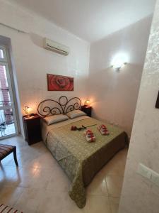 a bedroom with a bed with red shoes on it at Regina Elena Apartments in Taranto