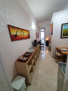 a living room with a counter with a painting on the wall at Regina Elena Apartments in Taranto