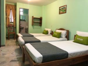 Postel nebo postele na pokoji v ubytování Hotel El Bosque