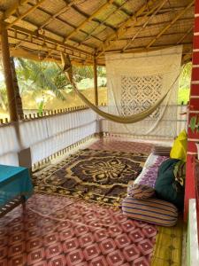 a room that has a rug and a bed in it at Secret Garden in Agonda