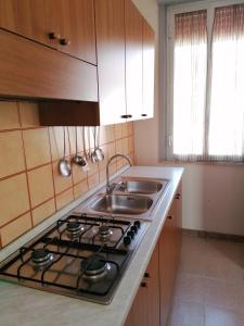 a kitchen with a stove and a sink at La Villetta sul mare in Marina di Modica +11 photos