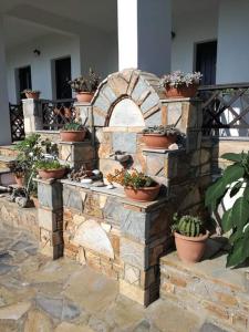 a stone wall with potted plants on it at Olga Paltsi Rooms in Paltsi Pilion