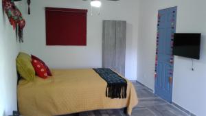 a bedroom with a bed and a tv in it at HospedArte Loreto in Loreto