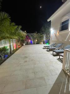 a patio at night with benches and a building at Villa white-design in Eilat