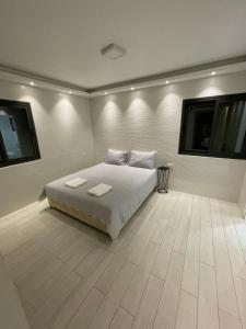 a bedroom with a bed with two pillows on it at Villa white-design in Eilat +56 photos