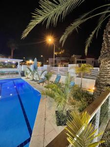 a swimming pool in a resort at night at Villa white-design in Eilat
