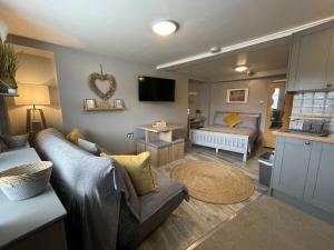 a living room with a couch and a bed at Westend Holiday Let 1 Brecon in Brecon