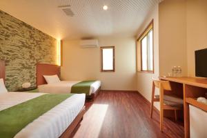 Kama o mga kama sa kuwarto sa Ichinomatsu Japanese Modern Hotel