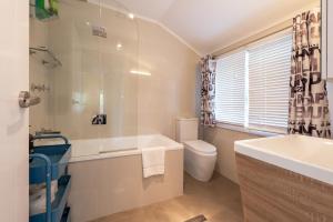a bathroom with a tub and a toilet and a sink at Blackheath Nook in Blackheath +16 photos