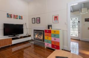 a living room with a tv and a fireplace at Blackheath Nook in Blackheath