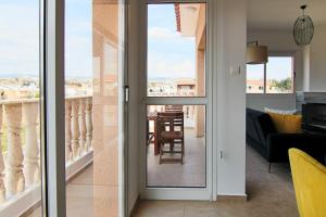 a sliding glass door leading to a living room at Phaedrus Living Cityview Luxury Flat Walnut Grove in Paphos