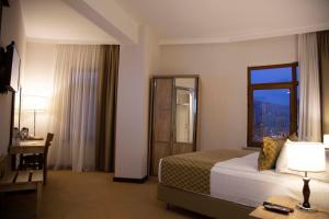A bed or beds in a room at ATLAS OTELİ