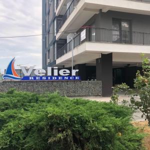 a building with a sign on the side of it at Velier Apartments 38 and 49 in Mamaia