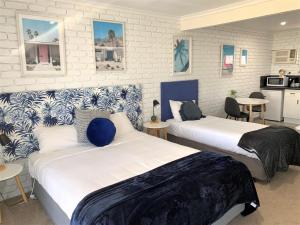 A bed or beds in a room at Mulwala Resort