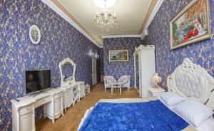 ブデンノフスクにあるHotel Nevskyの青い壁紙のベッドルーム(テレビ、ベッド付)