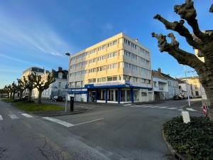 eine leere Straße mit einem hohen Gebäude an der Ecke in der Unterkunft The Originals City, Hôtel Napoléon, La Roche-sur-Yon (Inter-Hotel) in La Roche-sur-Yon